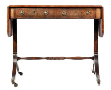 A late Regency period mahogany and rosewood cross-banded sofa table, fitted with two frieze drawers above twin supports with 