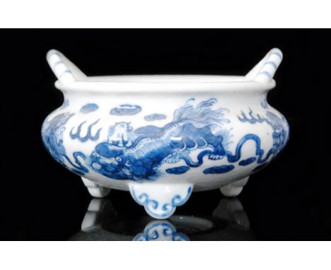 A Chinese blue and white bowl of compressed circular form with roll rim and applied arched handles, raised to three scroll fe