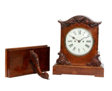 A mid 19th Century figured walnut bracket clock with twin fusee movement within an applied carved edge serpentine shaped case