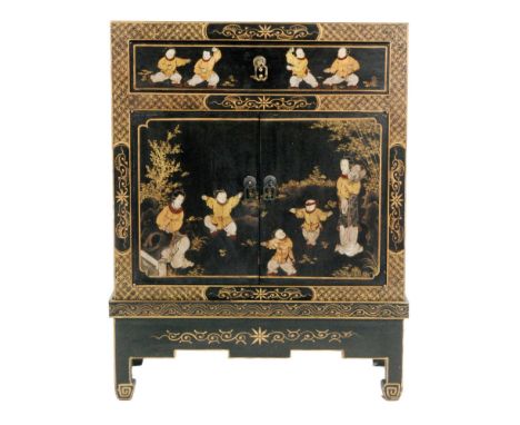 A 20th Century Chinese black painted cabinet, transfer printed with figural panels within gilded borders, fitted with a singl