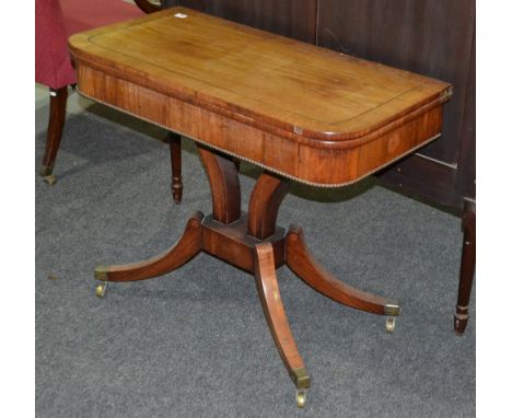 A 19th Century Regency style brass inlaid and crossbanded rosewood card table on twin column supports and splayed legs brass 