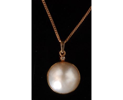 A 9ct mabe pearl and diamond pendant, the collar set pearl below brilliant cut collar set diamond highlight and suspended fro