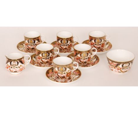 A set of six Royal Crown Derby breakfast cups and saucers decorated in an Imari pattern together with a matching milk jug and