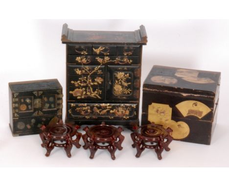 A late 19th Century Japanese trinket cabinet painted with a design of birds on flowering branches, width 42cm, together with 