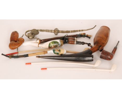 A collection of late 19th to early 20th Century German and English novelty pipes to include examples in clay, briar, Meerscha