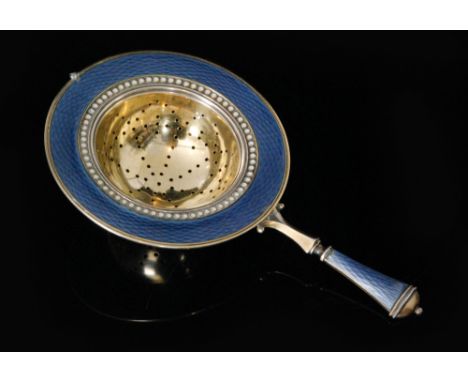 A Norwegian silver gilt tea strainer decorated with blue gillouche and white spot enamel highlights, length 12cm, David Ander