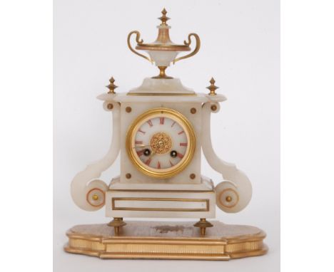 A Victorian alabaster mantle clock with eight day striking movement surmounted with a classical urn on plinth and separate ba