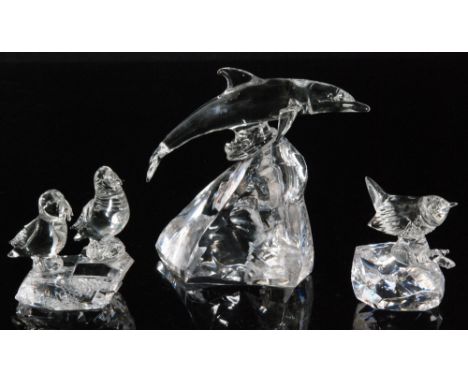A contemporary studio glass figure of a leaping dolphin lamp worked in clear crystal  by Neil Harris mounted to a facet block