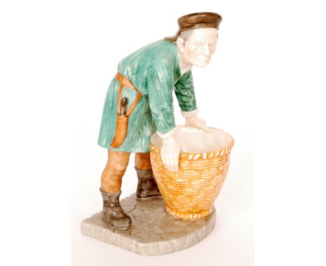 A Royal Worcester spill vase modelled as a fish seller leaning over a basket wearing a green overcoat, after James Hadley, im