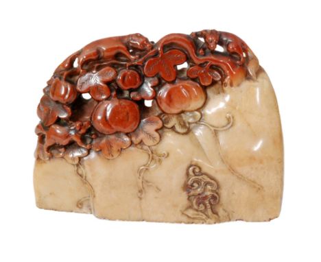 A 19th Century Chinese carved soapstone seal of slender section carved as a rock with lingzhi fungus below a fruiting peach b