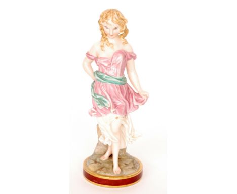 A 19th Century Royal Worcester figure by James Hadley modelled as a classical female in flowing pink robes with a jade green 