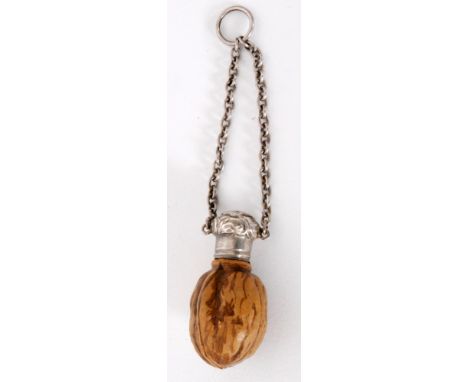 A Victorian scent bottle modelled as a walnut, the painted ceramic base below hallmarked embossed silver screw cap and finger