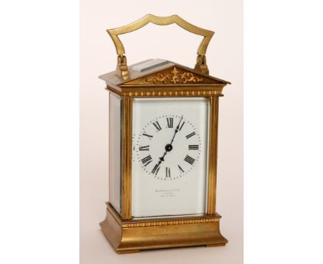 A late 19th Century French brass carriage clock of architectural Romanesque form, the white enamelled dial signed Benetfink &