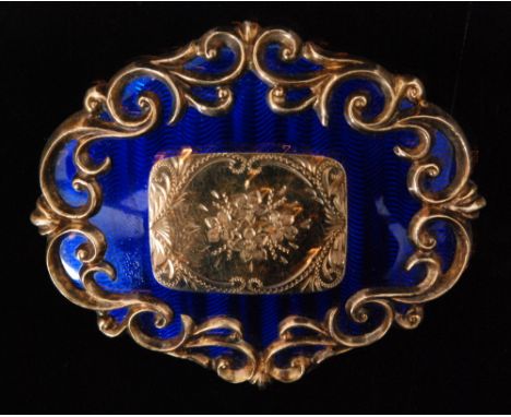 A Victorian 9ct oval brooch decorated with blue enamel to front surrounding central replaced gold foliate decorated panel, wi