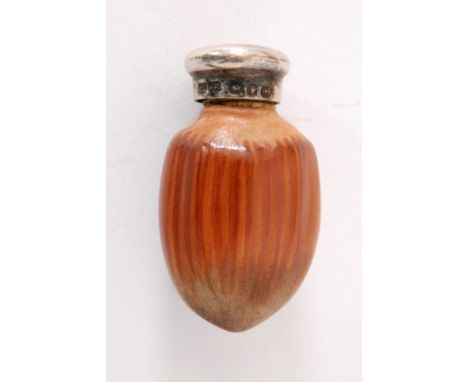 A Victorian scent bottle modelled as an acorn, the painted ceramic base below hallmarked silver screw cap, length 4cm, Birmin