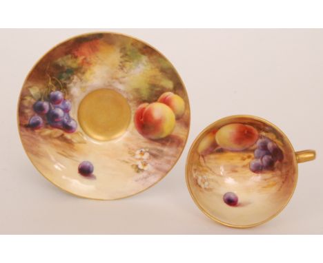 A small Royal Worcester cabinet cup and saucer decorated by W.H Austin with hand painted fallen fruits, the cup interior and 