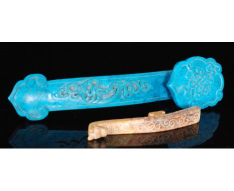 A 19th Century Chinese pale blue carved hardstone Ruyi sceptre with raised scroll work decoration, width 25cm and a similar h