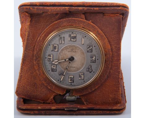 Omega - An Omega 8 day travel alarm clock, 6cm luminous arabic dial in a yellow metal case, top wind movement, all housed in 
