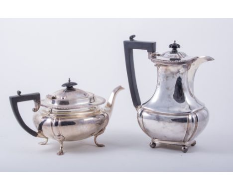 A Regency style silver tea pot, by James Deakin & Sons, Sheffield 1917, of swollen oblong form, with a gadrooned collar ebony