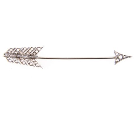 A diamond set stock pin/brooch, the 8cm long arrow set with four rose cut diamonds into the arrow head and twenty-nine rose c