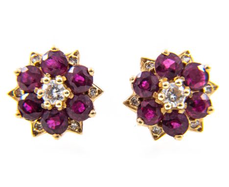 A pair of ruby and diamond circular cluster earrings, six rubies spaced by six, eight cut diamonds surrounding a central bril