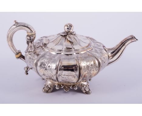 A George IV silver teapot, by Barnards, London 1826, compressed and lobed form with cast fruit finial, engraved foliate and s