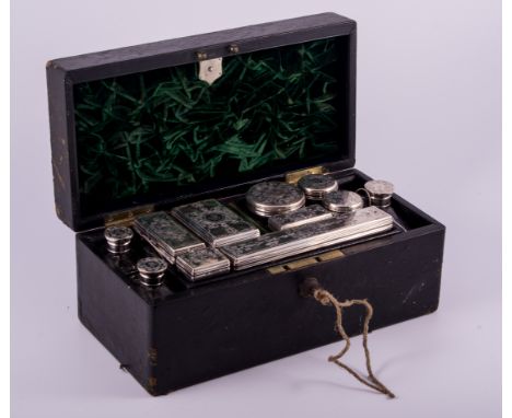 A Victorian black cloth travelling case, by J.T. Needs, 128 Piccadilly, fitted with eleven silver mounted bottles, jars and c