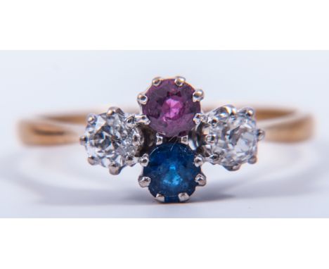 A diamond, sapphire and ruby four stone ring, a single sapphire and ruby claw set vertically with an old brilliant cut diamon