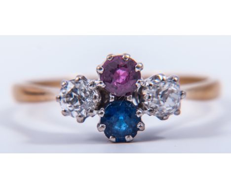 A diamond, sapphire and ruby four stone ring, a single sapphire and ruby claw set vertically with an old brilliant cut diamon