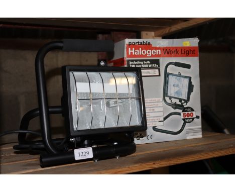 A portable halogen work light with original box