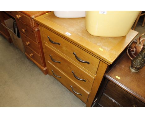 A modern light oak chest fitted three drawers