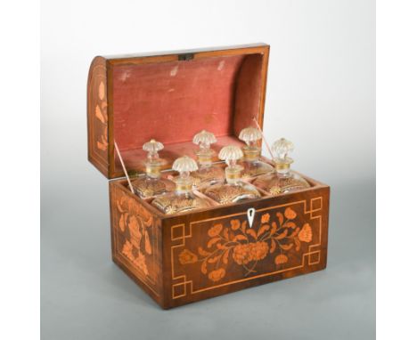 inlaid with flowers, the hinged lid revealing a velvet lined interior fitted with six gilt decorated glass decanters and stop