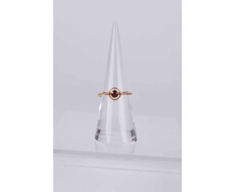 A 22 ct gold rub over set ruby target ring, size N 1/2, 2.1 g