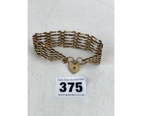 9k gold gate bracelet with heart lock, 7" long, w: 14.2 gms
