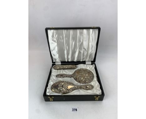 Cased silver brush, mirror and comb set with purchase receipt from 1975