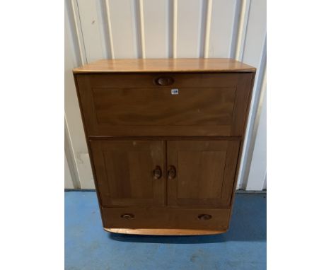 Mid-brown Ercol cupboard with pull-down front, double cupboard and base drawer on castors. 32.5"w x 19"d x 43"h