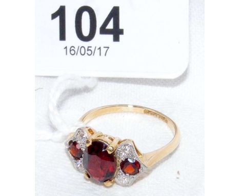 An 18ct yellow gold garnet and diamond dress ring