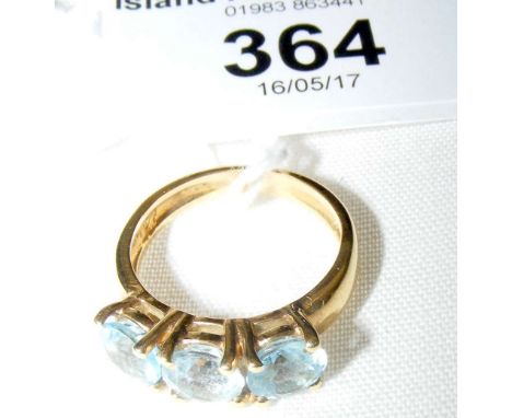 A blue topaz three stone ring in 18ct gold setting