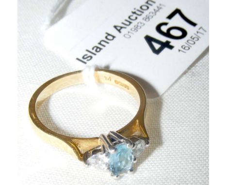 An aquamarine and diamond three stone ring in 18ct gold setting