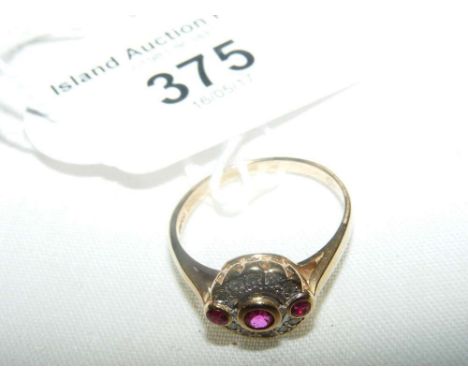 A ruby and diamond cluster ring in 14ct gold setting