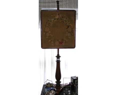 A Victorian mahogany pole screen with tapestry panel