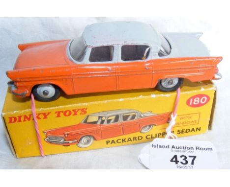 A boxed Dinky Toys No.180 Packard Clipper Sedan in orange and grey