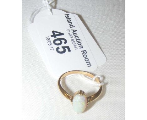 A single stone opal dress ring in 18ct gold setting