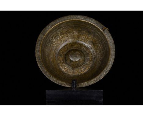 19th century. Iran or Central Asia. Qajar style. Persian Qajar Dynasty chiselled brass "magic" bowl. Rounded form on short ta