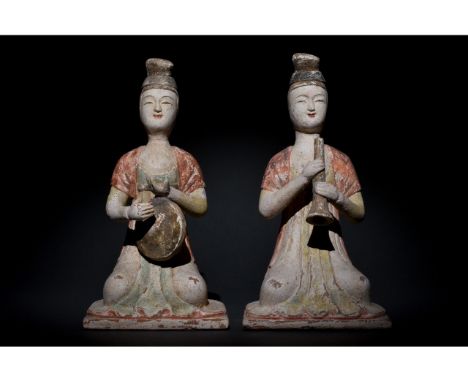 Ca. 618 to 906 AD. Tang Dynasty. Pair of terracotta female musician figures. One is playing a drum, the other one is playing 