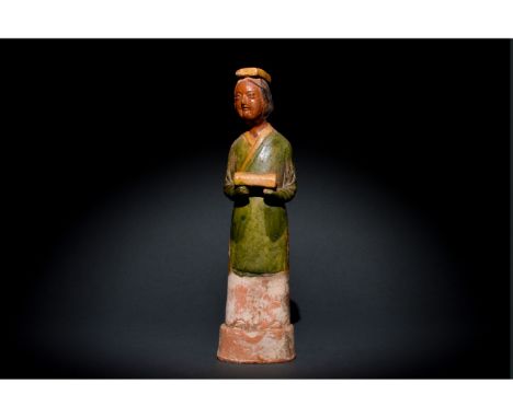 c. 1271-1368. Yuan dynasty. The elegant standing figure wearing a green dress draped around her shoulders, holding an unident