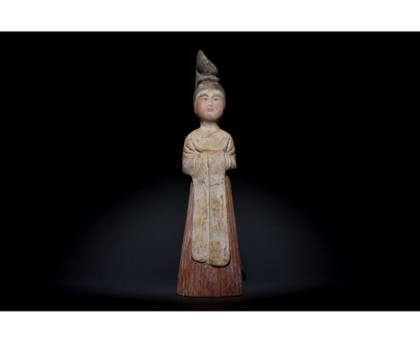 Ca. 618-906 AD. Tang Dynasty. A finely moulded Tang Dynasty terracotta figurine of a female court attendant, depicted standin