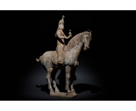 C. 618 - 907 AD. Chinese Tang Dynasty. An unusual and beautiful moulded figure of a horse and its rider. The horse is modelle