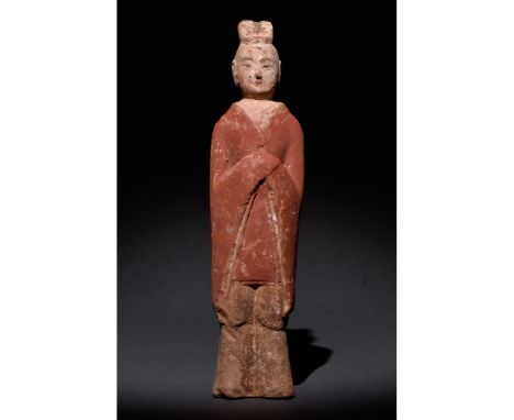 C. 500 AD. Chinese Northern Wei Dynasty. An elaborately crafted male attendant figure dressed in a rich red tunic and brown t