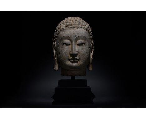 C. AD 618-907. Tang Dynasty. Large stone head of Buddha with carefully modeled hair that allows us to distinguish individual 